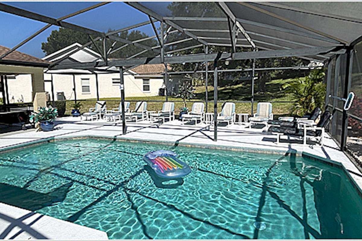 Pool area with extended deck, table tennis and lanai